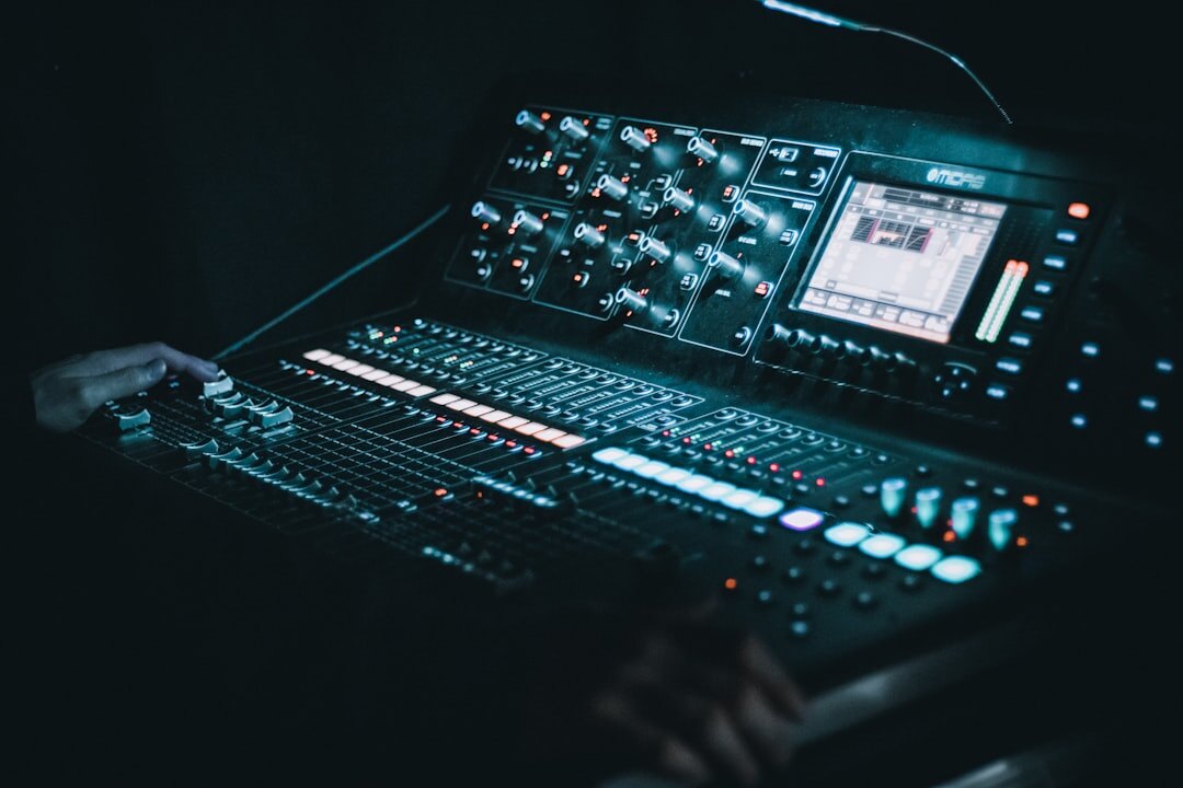 Audio mixing console with sliders and meters