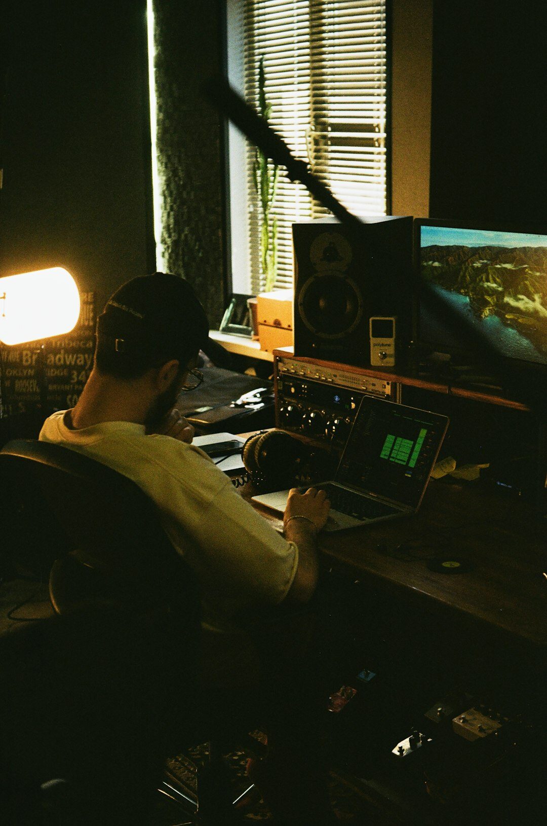 Video engineer working at a multi-monitor broadcast desk